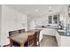 Bright kitchen featuring white cabinets, stainless steel appliances, and an island with seating at 2020 Rainbow View St, Henderson, NV 89012