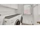 Bright laundry room with front-loading washer and dryer, door, and ample storage at 2020 Rainbow View St, Henderson, NV 89012