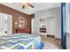 Spacious bedroom with hardwood floors, walk-in closet, and ceiling fan at 2020 Rainbow View St, Henderson, NV 89012