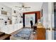 Well-lit office space featuring custom built-in shelving and a ceiling fan at 2020 Rainbow View St, Henderson, NV 89012
