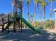 This park includes a green playground and tall palm trees at 2020 Rainbow View St, Henderson, NV 89012