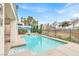 Sparkling pool with mature landscaping, spa, and spacious concrete surround, perfect for summer relaxation at 2020 Rainbow View St, Henderson, NV 89012