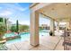 Inviting backyard with a sparkling pool, spa, and covered patio, perfect for outdoor living at 2020 Rainbow View St, Henderson, NV 89012