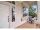 Inviting front porch features neutral walls, a window and an accent chair at 2020 Rainbow View St, Henderson, NV 89012