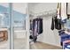 Walk-in closet with custom shelving, tile floor, and natural light at 2020 Rainbow View St, Henderson, NV 89012