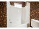 Bathroom featuring a tub and shower combo with decorative wallpaper at 2050 W Warm Springs Rd # 4322, Henderson, NV 89014