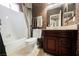Bathroom featuring a tub with shower, vanity with sink, and decorative wallpaper at 2050 W Warm Springs Rd # 4322, Henderson, NV 89014