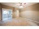 Spacious bedroom with neutral carpet, ceiling fan, and a sliding glass door at 2050 W Warm Springs Rd # 4322, Henderson, NV 89014