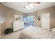 Bedroom with neutral walls and patterned bedding, complemented by natural light and a balcony access at 2050 W Warm Springs Rd # 4322, Henderson, NV 89014