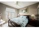 Cozy bedroom with window, ceiling fan, and comfortable bed with bedside tables at 2050 W Warm Springs Rd # 4322, Henderson, NV 89014