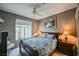 Comfortable bedroom with a ceiling fan, window view, and bedside lamps at 2050 W Warm Springs Rd # 4322, Henderson, NV 89014