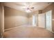 Carpeted bedroom with ceiling fan, and doors to the bathroom and closet at 2050 W Warm Springs Rd # 4322, Henderson, NV 89014