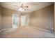 Carpeted bedroom with ceiling fan and adjoining bathroom and closet doors at 2050 W Warm Springs Rd # 4322, Henderson, NV 89014