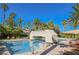 Resort pool with bridge, lounge chairs, and tropical palm trees at 2050 W Warm Springs Rd # 4322, Henderson, NV 89014