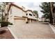 View of the home's exterior with multiple garage doors and ample parking at 2050 W Warm Springs Rd # 4322, Henderson, NV 89014