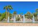 Elegant exterior view of a home with palm trees, fountain, and manicured landscaping at 2050 W Warm Springs Rd # 4322, Henderson, NV 89014