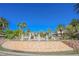 Wide view of a fountain surrounded by palm trees and lush landscaping in a desert community at 2050 W Warm Springs Rd # 4322, Henderson, NV 89014