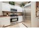 Bright kitchen with stainless steel appliances, white cabinets, and neutral countertops at 2050 W Warm Springs Rd # 4322, Henderson, NV 89014