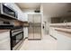 Kitchen features stainless steel appliances, white cabinets, and a tiled floor at 2050 W Warm Springs Rd # 4322, Henderson, NV 89014