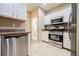 Bright kitchen featuring stainless steel appliances, white cabinetry, and a tile floor at 2050 W Warm Springs Rd # 4322, Henderson, NV 89014