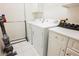 Bright laundry room with modern washer, dryer, and storage cabinets at 2050 W Warm Springs Rd # 4322, Henderson, NV 89014