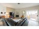 Cozy living room with fireplace, tile flooring, and sliding glass doors to an outdoor space at 2050 W Warm Springs Rd # 4322, Henderson, NV 89014