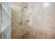 Close-up of the shower's fixtures and travertine tile at 2050 W Warm Springs Rd # 4322, Henderson, NV 89014