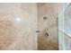 Shower with travertine tiled walls, rainfall showerhead, and a glass block wall at 2050 W Warm Springs Rd # 4322, Henderson, NV 89014