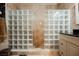 Luxurious travertine-tiled shower stall with glass block wall adding natural light at 2050 W Warm Springs Rd # 4322, Henderson, NV 89014