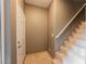 Interior view of a staircase with tan walls and a white front door at 2050 W Warm Springs Rd # 4322, Henderson, NV 89014
