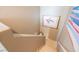 An upper stairway landing is decorated with paintings and tiled floor at 2050 W Warm Springs Rd # 4322, Henderson, NV 89014