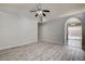 Spacious living room featuring wood-look flooring and an arched doorway to the dining area at 2471 Grand Basin Dr, Las Vegas, NV 89156