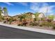 Charming single-story home featuring a tile roof, neutral stucco, and beautifully landscaped front yard at 2491 Hardin Ridge Dr, Henderson, NV 89052