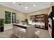 Bright office with built-in bookcase, white modern desk, ceiling fan, and a large window at 2491 Hardin Ridge Dr, Henderson, NV 89052