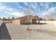 Spacious backyard with low maintenance gravel, bare tree, patio, and secure fencing, offering privacy and potential at 2648 E Sparrow Way, Pahrump, NV 89048