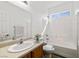 Bathroom with a shower-tub combo, wood-look cabinets and a bright window at 2648 E Sparrow Way, Pahrump, NV 89048