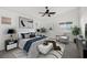 This primary bedroom has a ceiling fan, white walls, modern decor and multiple windows at 2648 E Sparrow Way, Pahrump, NV 89048