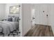 Hallway view with bedroom featuring a gray bed and stylish patterned carpet at 2648 E Sparrow Way, Pahrump, NV 89048