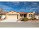 Charming single-story home featuring a neutral color palette, tile roof, and a well-manicured front yard at 2648 E Sparrow Way, Pahrump, NV 89048