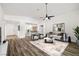 Bright, open-concept living room featuring wood flooring, contemporary furniture, and an abundance of natural light at 2648 E Sparrow Way, Pahrump, NV 89048