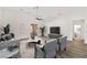 Spacious living room with wood floors, modern decor, and a sliding glass door leading to the outdoor area at 2648 E Sparrow Way, Pahrump, NV 89048