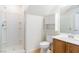 Bathroom with a walk-in shower and a vanity with wood cabinetry at 304 Iron Summit Ave, North Las Vegas, NV 89031