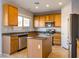 Kitchen featuring a center island, stainless steel appliances, and wooden cabinets at 304 Iron Summit Ave, North Las Vegas, NV 89031