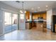Bright kitchen with stainless steel appliances and a sliding glass door leading to the patio at 304 Iron Summit Ave, North Las Vegas, NV 89031