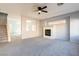 Inviting living room features a cozy fireplace, plush carpeting, and an open floor plan design at 304 Iron Summit Ave, North Las Vegas, NV 89031