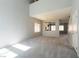 Expansive living room featuring neutral carpet, high ceilings, and natural light from multiple windows at 304 Iron Summit Ave, North Las Vegas, NV 89031