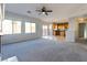 Bright living room with large windows and an open floor plan leading to the kitchen at 304 Iron Summit Ave, North Las Vegas, NV 89031