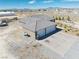New home construction featuring a three-car garage and desert landscape at 3050 Oakridge Ave, Pahrump, NV 89048
