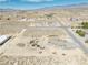 Wide aerial shot showing desert property with house, pool, and large lot at 3050 Oakridge Ave, Pahrump, NV 89048
