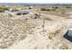 An aerial view of a property and surrounding land, desert landscaping, and neighborhood homes at 3050 Oakridge Ave, Pahrump, NV 89048